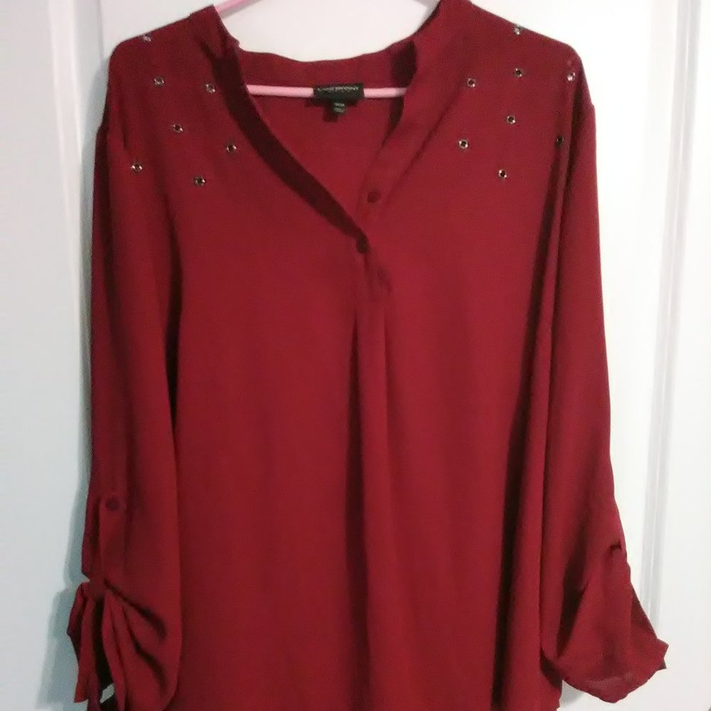 Red long sleeve shirt with grommet design on front